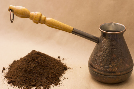Abstract figure photography for editors, designers and artists with copper coffee pot, pile of coffee, pepper and little clay cupの写真素材