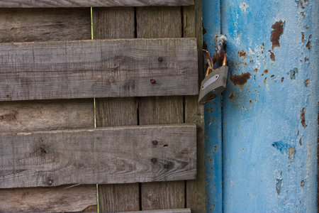 Background photo of old rusty keylock and closed gates for design of advertisement promoの写真素材