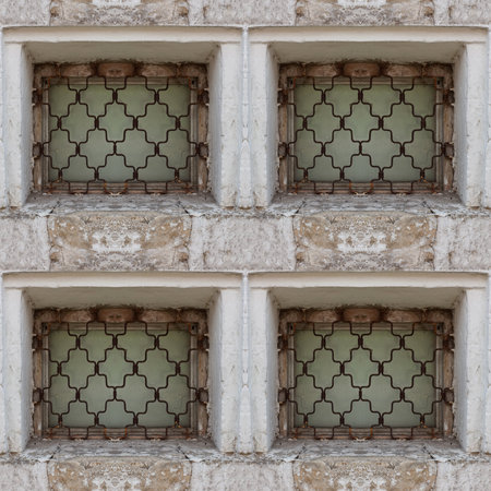 Seamless pattern of ancient castle window with big stone blocks and rust barsの写真素材