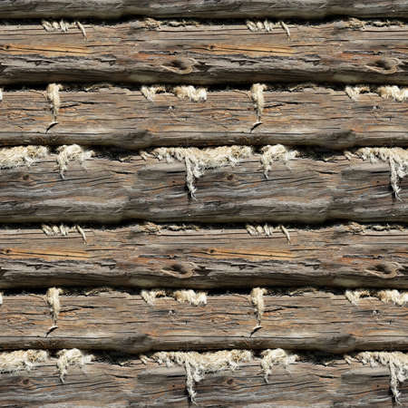 Seamless texture of the sealed wall of an old log house with cracksの写真素材