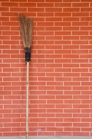 Broom brick on wall の写真素材
