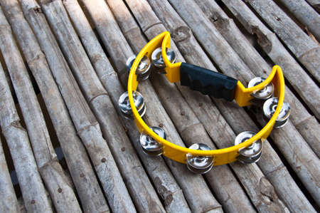 yello tambourine on wooden floor