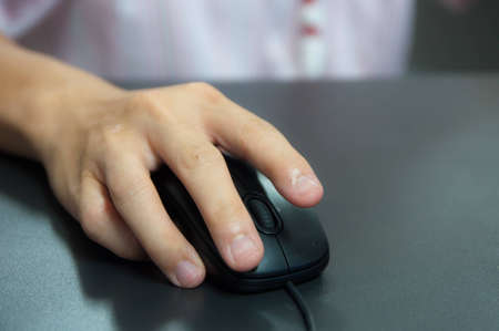 hand holding computer mouseの写真素材