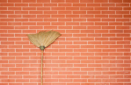 Broom on brick wallの写真素材