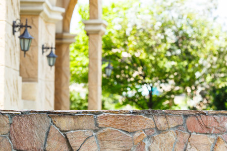 Wall of stones and bokeh tree backgroundの写真素材