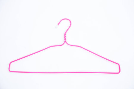 Pink wire hangers on white backgroundの写真素材