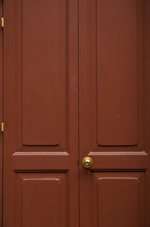 Door knob gold color with brown doorの写真素材