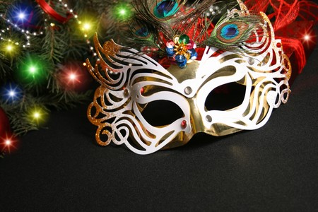 Mask and Christmas light. Carnival the mask is isolated on a black backgroundの写真素材
