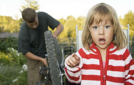 Village children repaired a bicycle. The focus to the girl.の写真素材