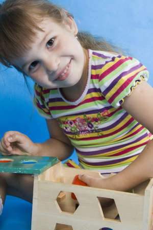 Fan little girl play. Isolated blue.