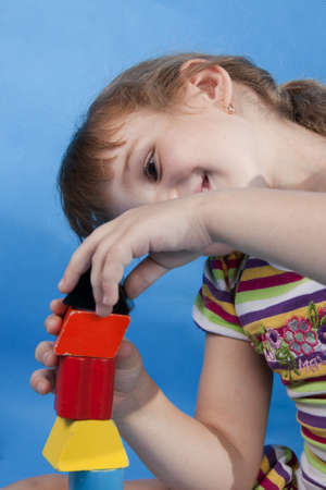 Fan little girl play. Isolated blue.