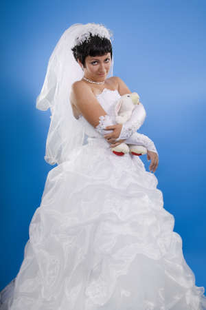 One happy and Beautiful  bride on blue background. の写真素材