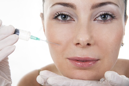 Cosmetic treatment with botox injection. White isolated.の写真素材