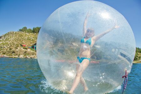 Joyful children in a balloon floating on water.の写真素材