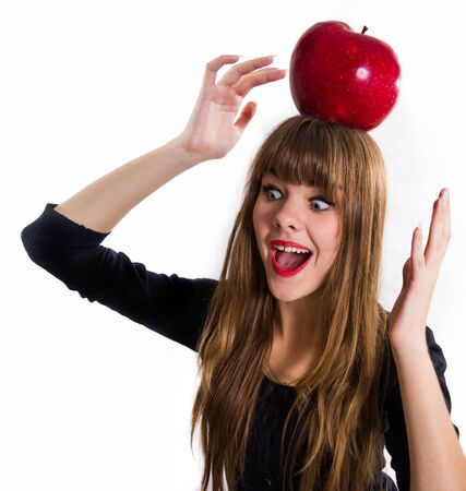 The pretty, young Girl and red apple. Isolated on white.の写真素材