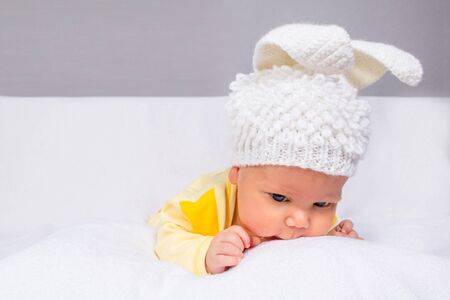 The baby in a white knitted hatの写真素材