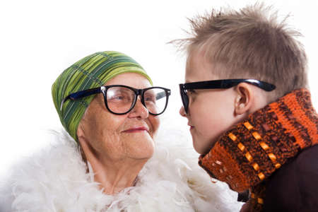 Cheerful and joyful grandmother and the grandson communicate playing, in the hipster glassesの写真素材