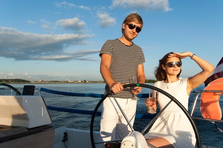 Happy young couple relaxing on a yachtの写真素材