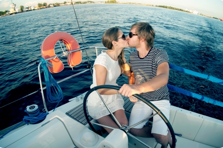 Happy young couple relaxing on a yachtの写真素材