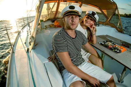 Happy young couple relaxing on a yachtの写真素材
