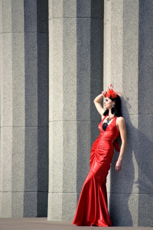 Beautiful young woman in a red dressの写真素材