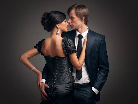 Stylish man in a suit and a girl in an evening black dressの写真素材