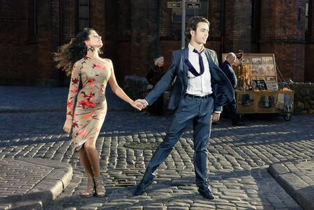 young couple dancing tango on the streets of the old city
