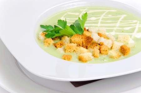 Green soup with croutonsの写真素材