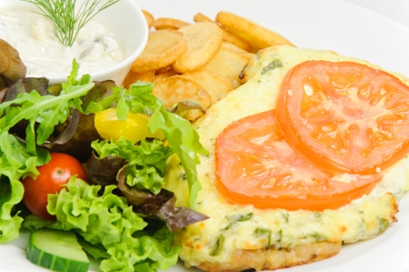 Meat in French with French fries and vegetablesの写真素材
