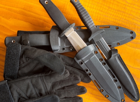 Military knives and scabbard on the wooden backgroundの写真素材