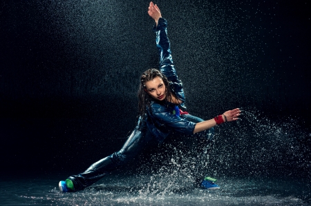 Wet dancing woman. Under waterdrops. Studio photoの写真素材