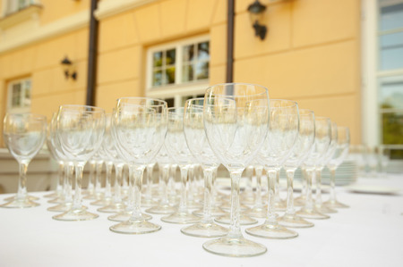 Wine glasses on white table outdoorsの写真素材