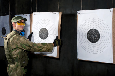 Man with target in shooting rangeの写真素材
