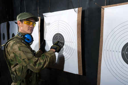 Man with target in shooting rangeの写真素材