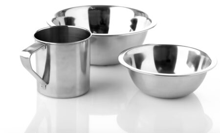 Metal plates and cup isolated on whiteの写真素材