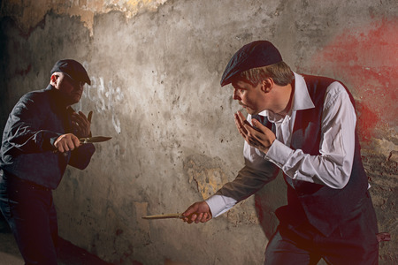 Men fighting with knives at urban streetの写真素材