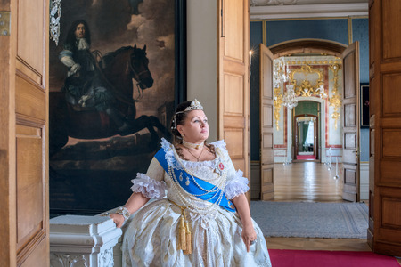 Historical cosplay. Beautiful woman in the similitude of Catherine the Great, empress of Russia ancient dress in the palaceのeditorial素材
