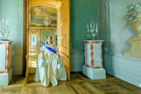 Historical cosplay. Beautiful woman in the similitude of Catherine the Great, empress of Russia ancient dress in the palaceのeditorial素材