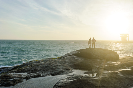 Two people on Indian Ocean coast in Kanyakumary the southernmost point of the Indian subcontinental,...