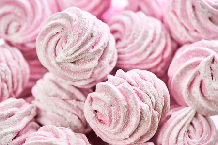 Served hand made zephyr from apples and raspberry on plate with cap of teaの写真素材