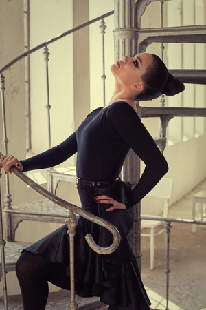 Elegant latin women dancer at spin stairs in grunge interior styleの写真素材