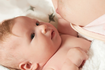 The two month old blond baby boy have a breast milkの写真素材