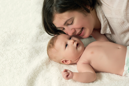 Two month old blond baby boy take care with motherの写真素材