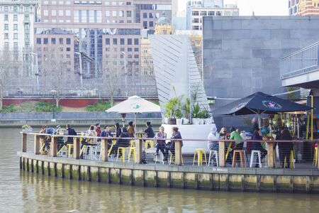 Melbourne, Australia - July 22, 2015: View of people in Ponyfish Island cafe, a restaurant bar surrounded by water, in Melbourne, Australia during daytime.のeditorial素材