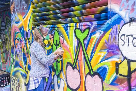 Melbourne, Australia - August 30, 2015: An artist painting in Hosier Lane in Melbourne. Hosier Lane is one of the city's best street art locations.のeditorial素材