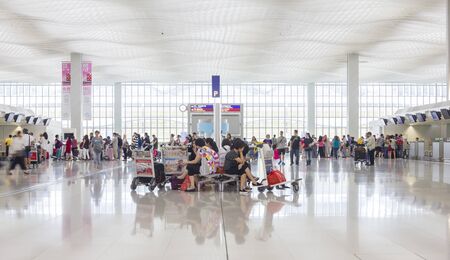 Hong Kong, China - June 23, 2015: Passengers waiting and queuing up in check-in counter in Hong Kong International Airport.のeditorial素材