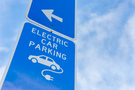 Electric car parking sign in blue with arrowの写真素材
