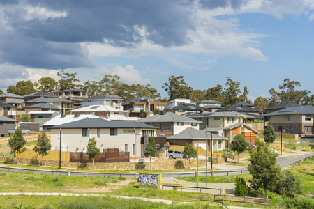 Melbourne, Australia - October 11, 2015: Row of new, modern suburban houses on the hill in Melbourne with trees during daytime.のeditorial素材