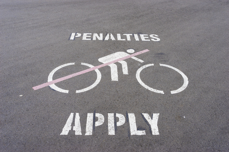 Penalties apply and no cycling wordings and graphics on the roadの写真素材