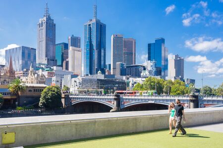 Melbourne, Australia - February 27, 2016: Tourists walking with Melbourne skyline as the background during daytime. Melbourne is ranked the world's most liveable city in sixth consecutive years.のeditorial素材
